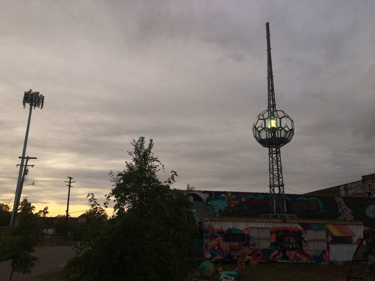 Wide view at sunset — beacon tower alongside a cell tower