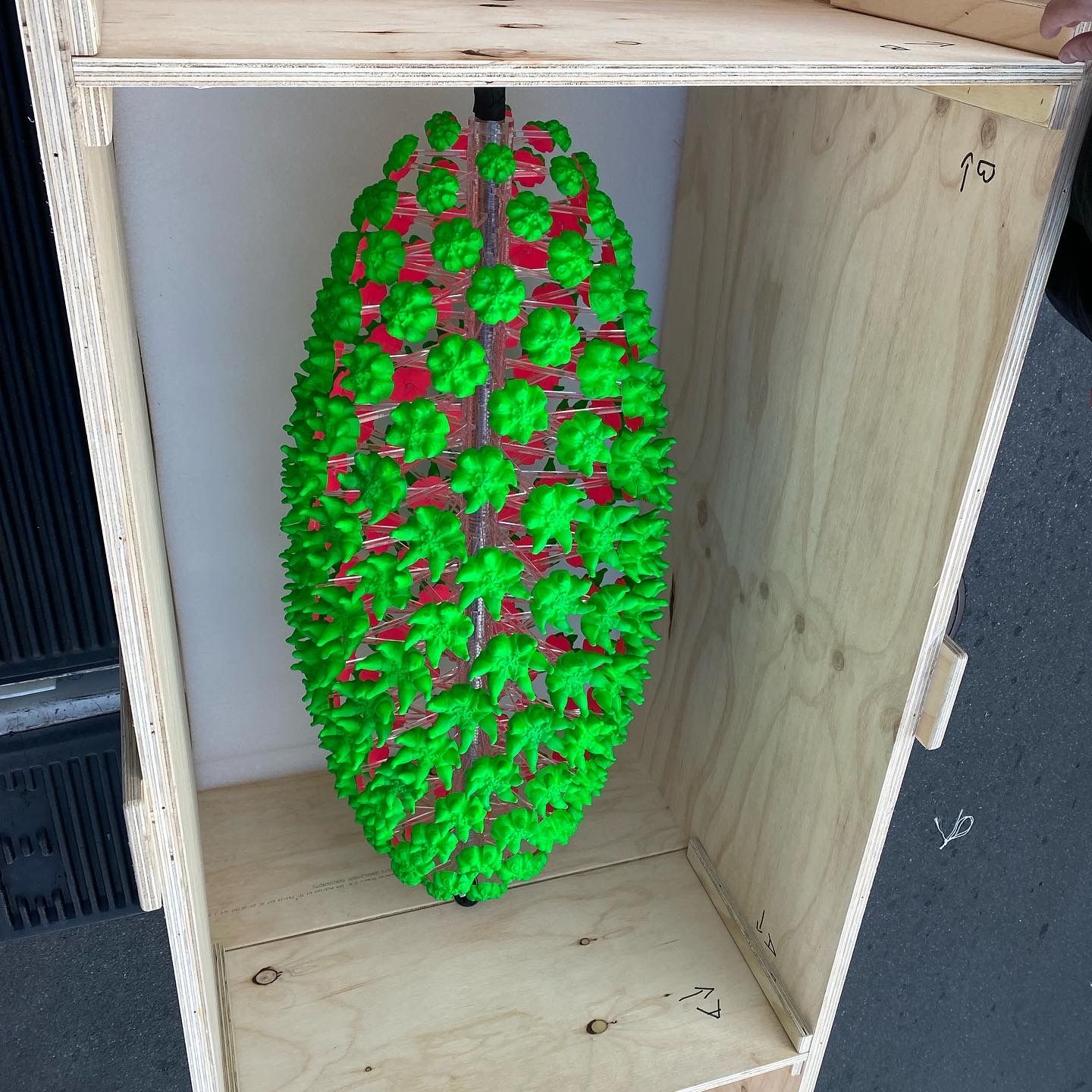 Spike ball sculpture packed in a shipping crate