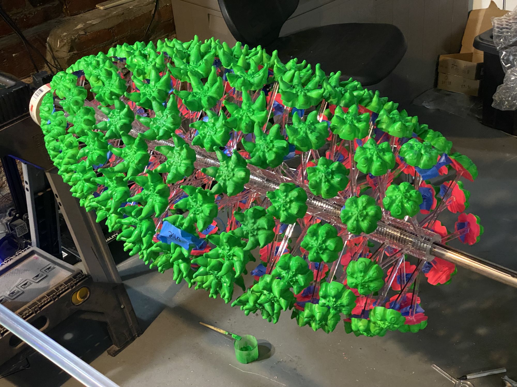 Zoetrope disc on the workbench — UV-reactive spike sculptures in green, red, and blue